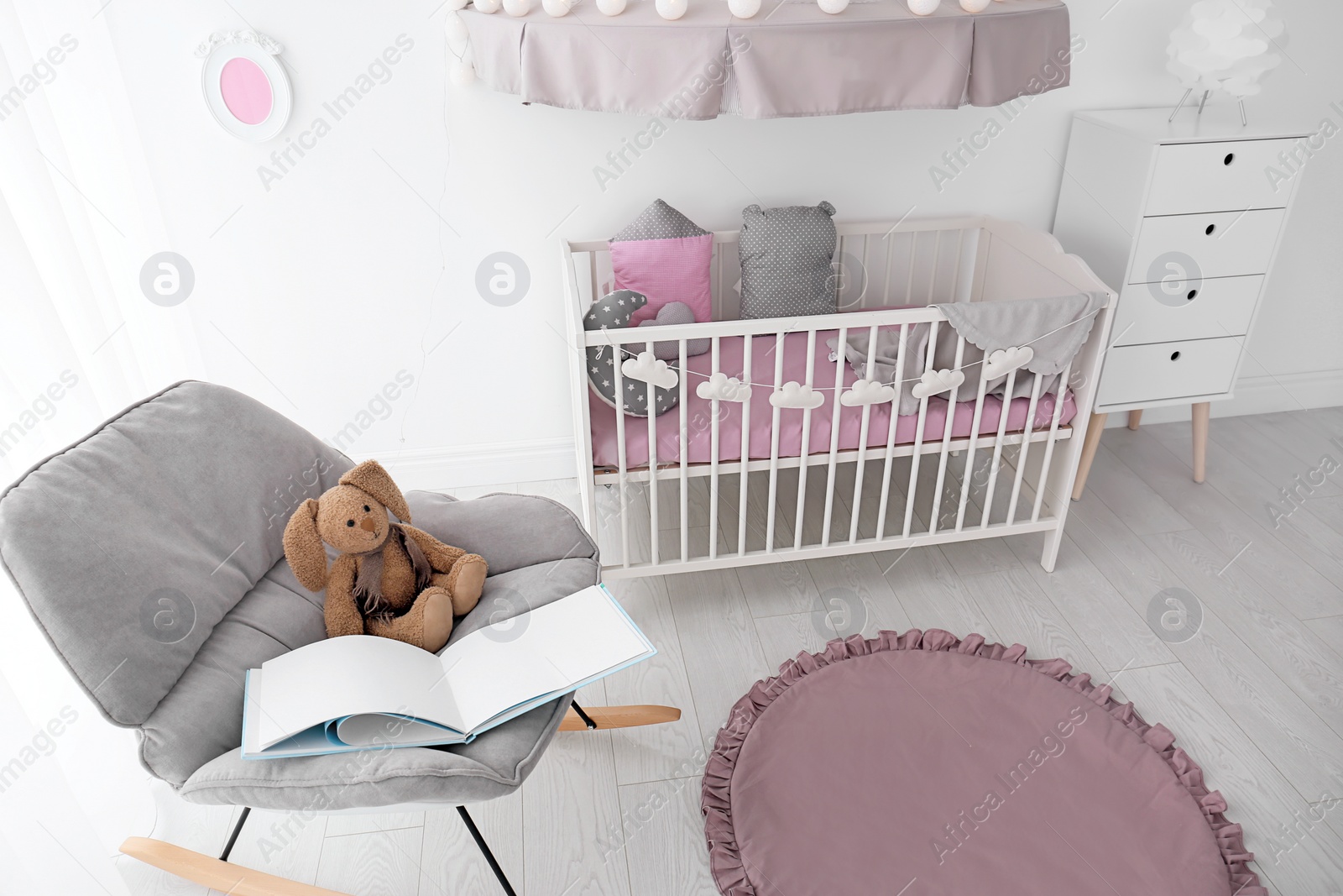 Photo of Interior of baby room with comfortable crib