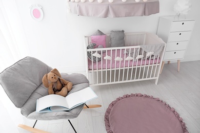 Photo of Interior of baby room with comfortable crib