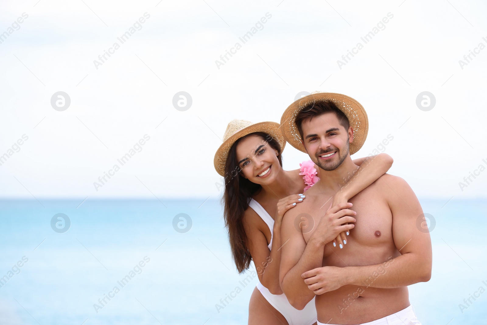 Photo of Happy young couple spending time together on beach