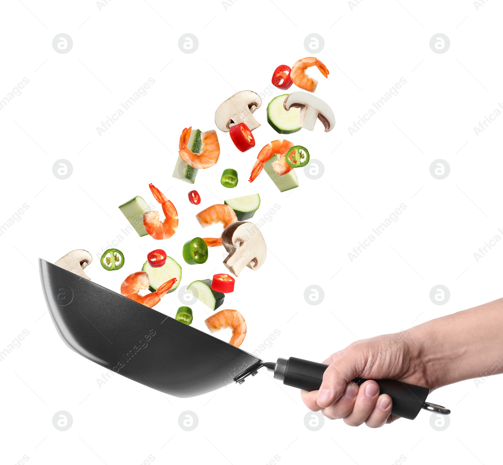 Image of Man tossing ingredients in wok on white background, closeup