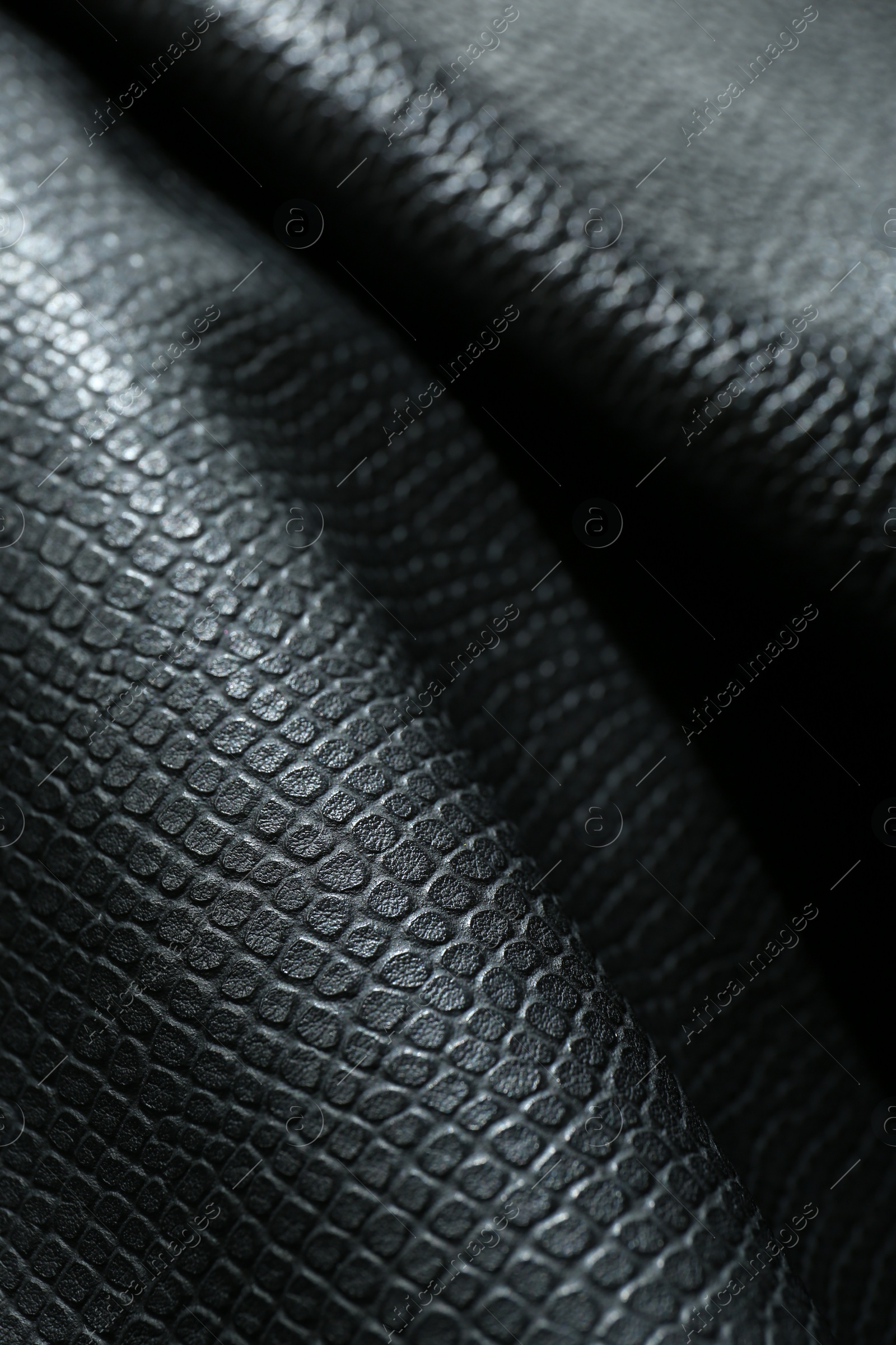 Photo of Black natural leather as background, closeup view