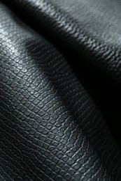 Black natural leather as background, closeup view