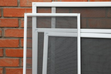 Photo of Set of window screens near brick wall
