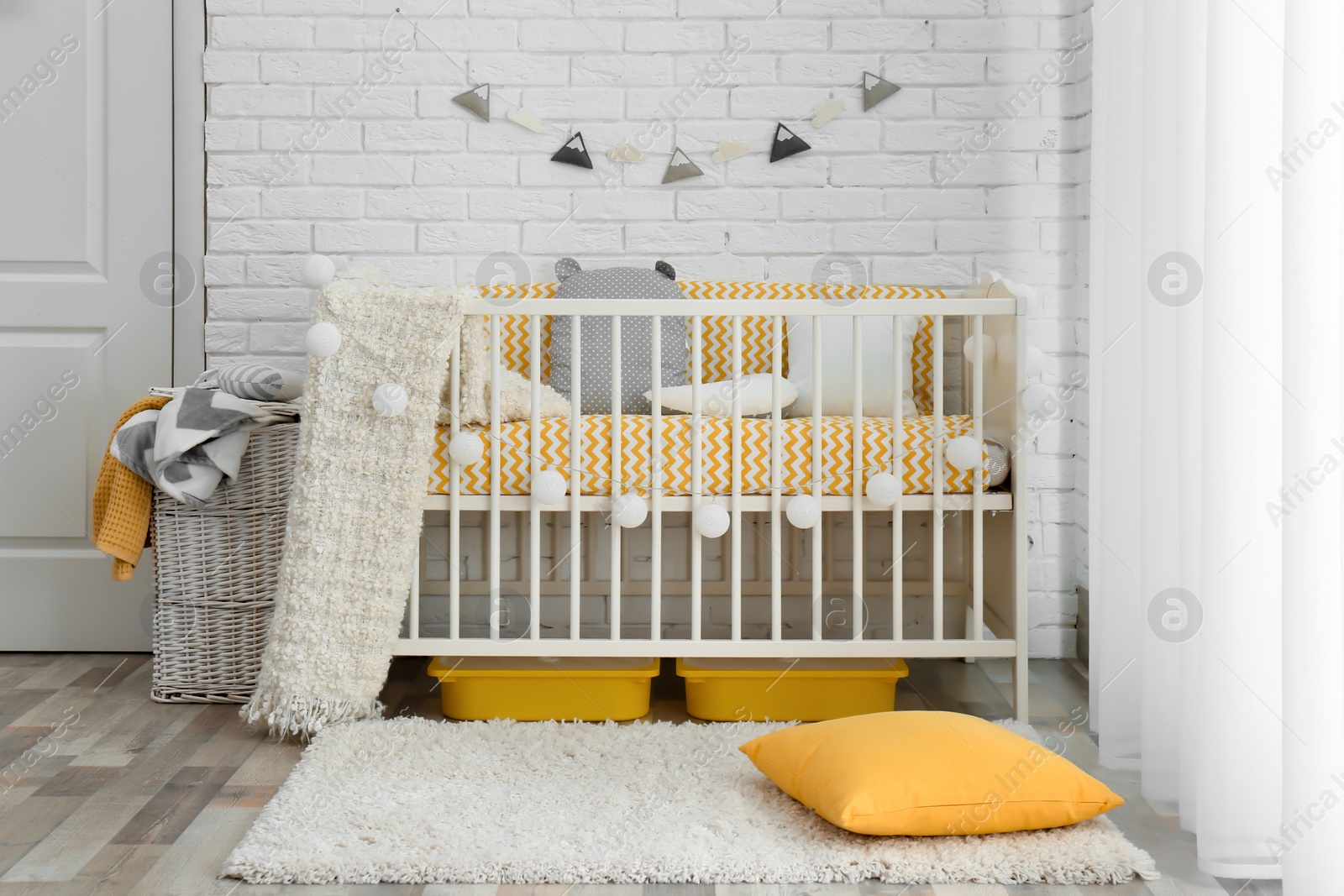 Photo of Stylish baby room interior with crib