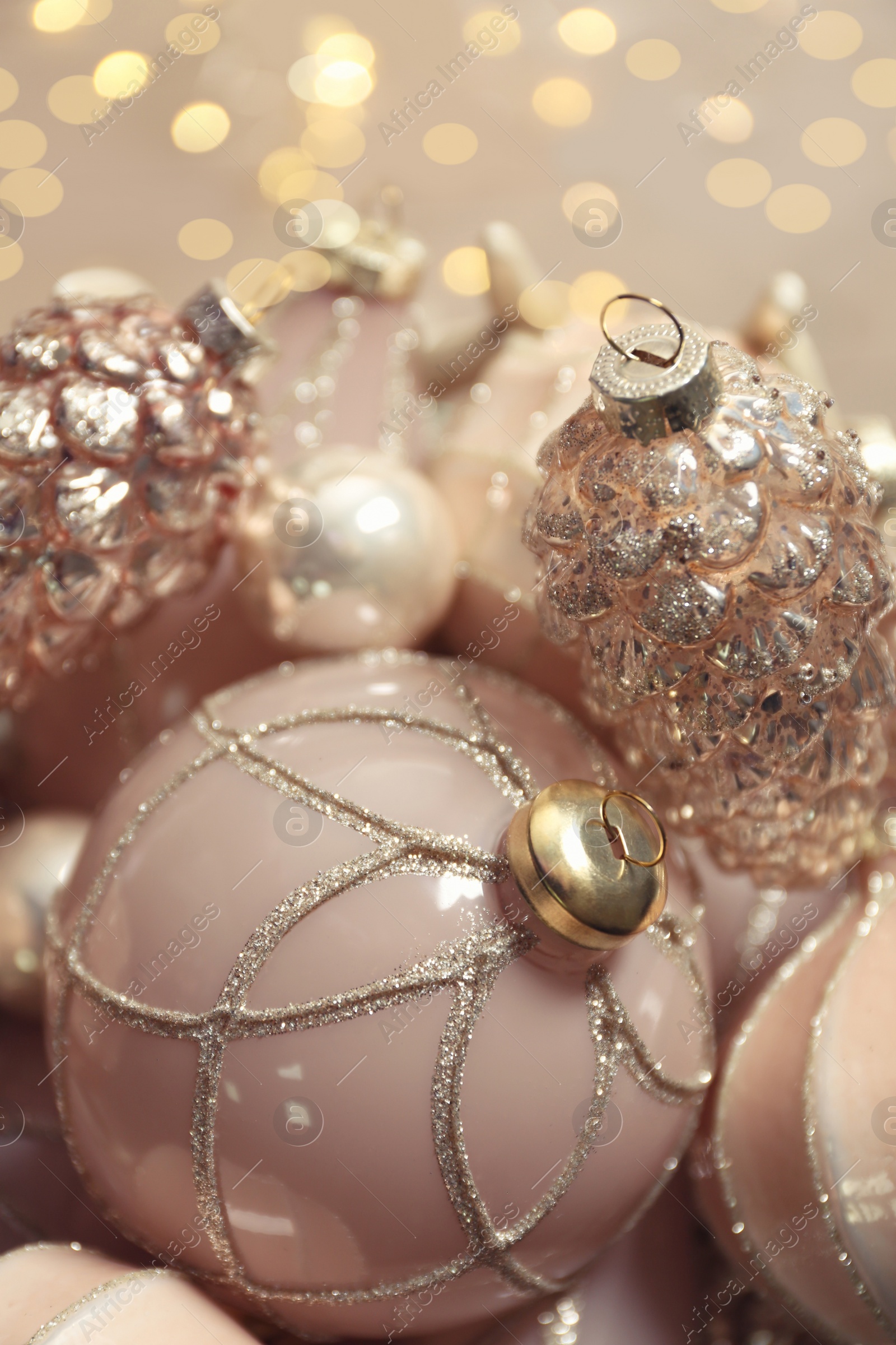 Photo of Collection of beautiful Christmas tree baubles against blurred festive lights, closeup