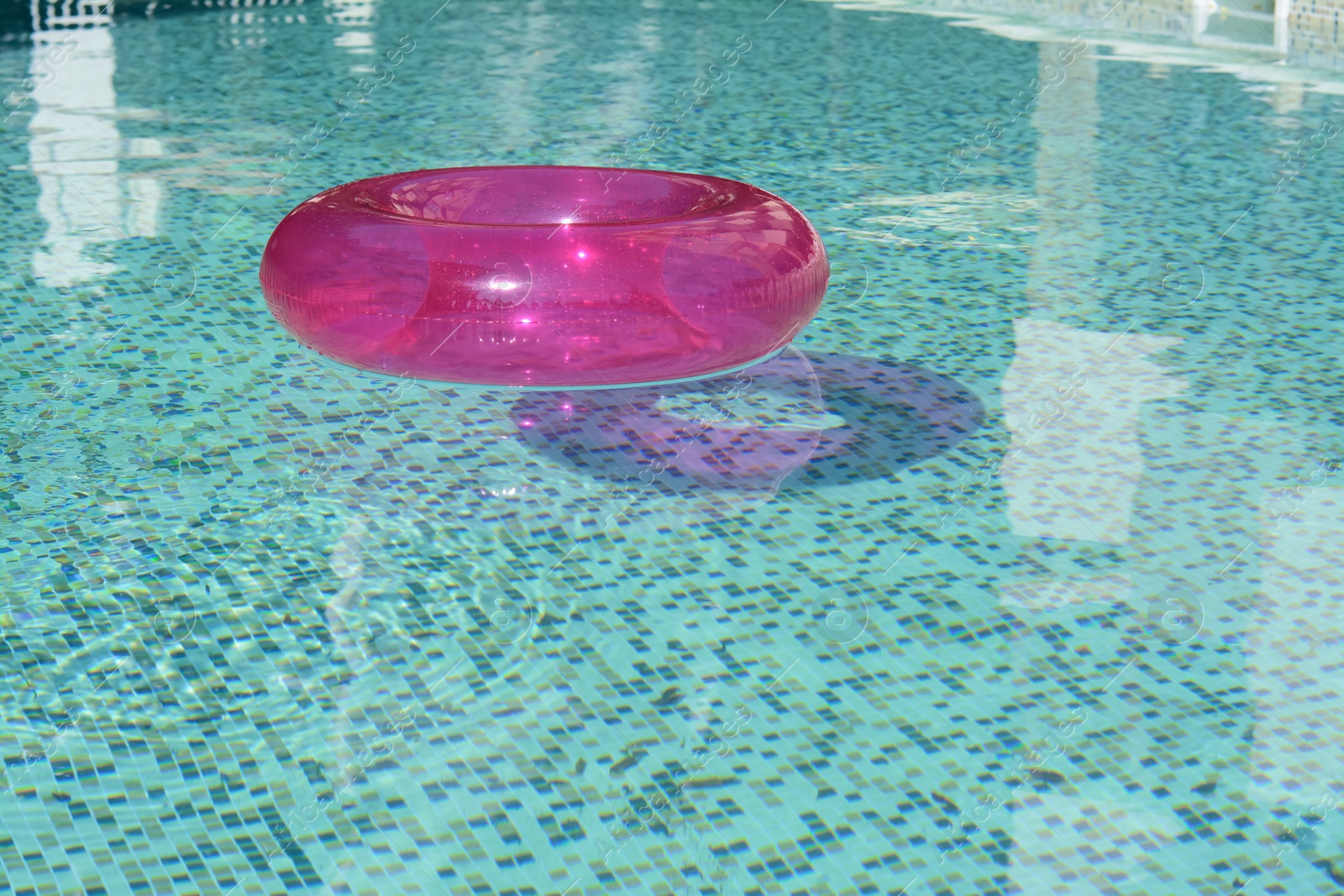 Photo of Inflatable ring floating on water in swimming pool