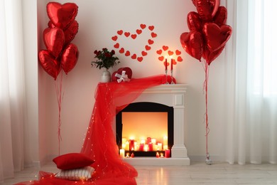 Stylish room with fireplace and Valentine's day decor. Interior design