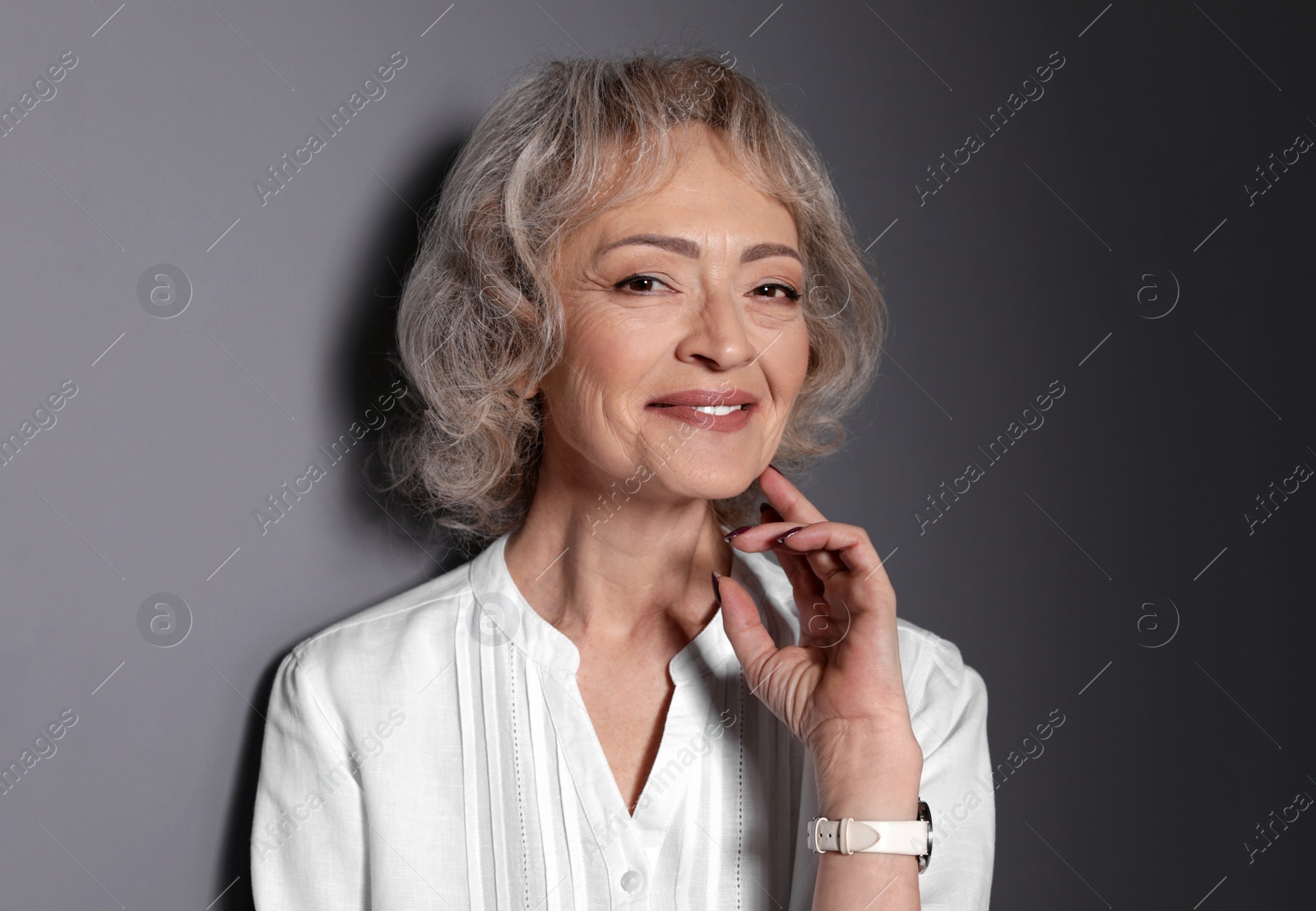 Photo of Portrait of mature woman on grey background