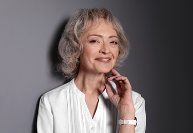 Photo of Portrait of mature woman on grey background