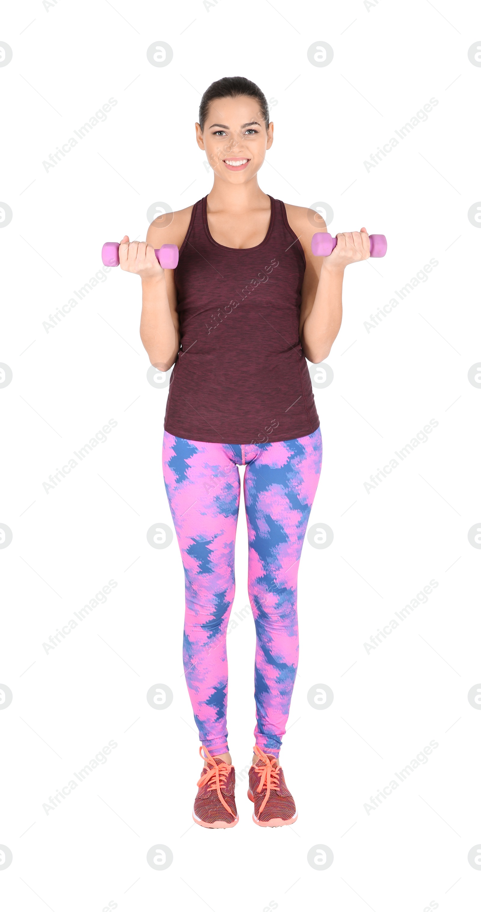 Photo of Young beautiful woman with dumbbells doing exercise on white background. Home fitness