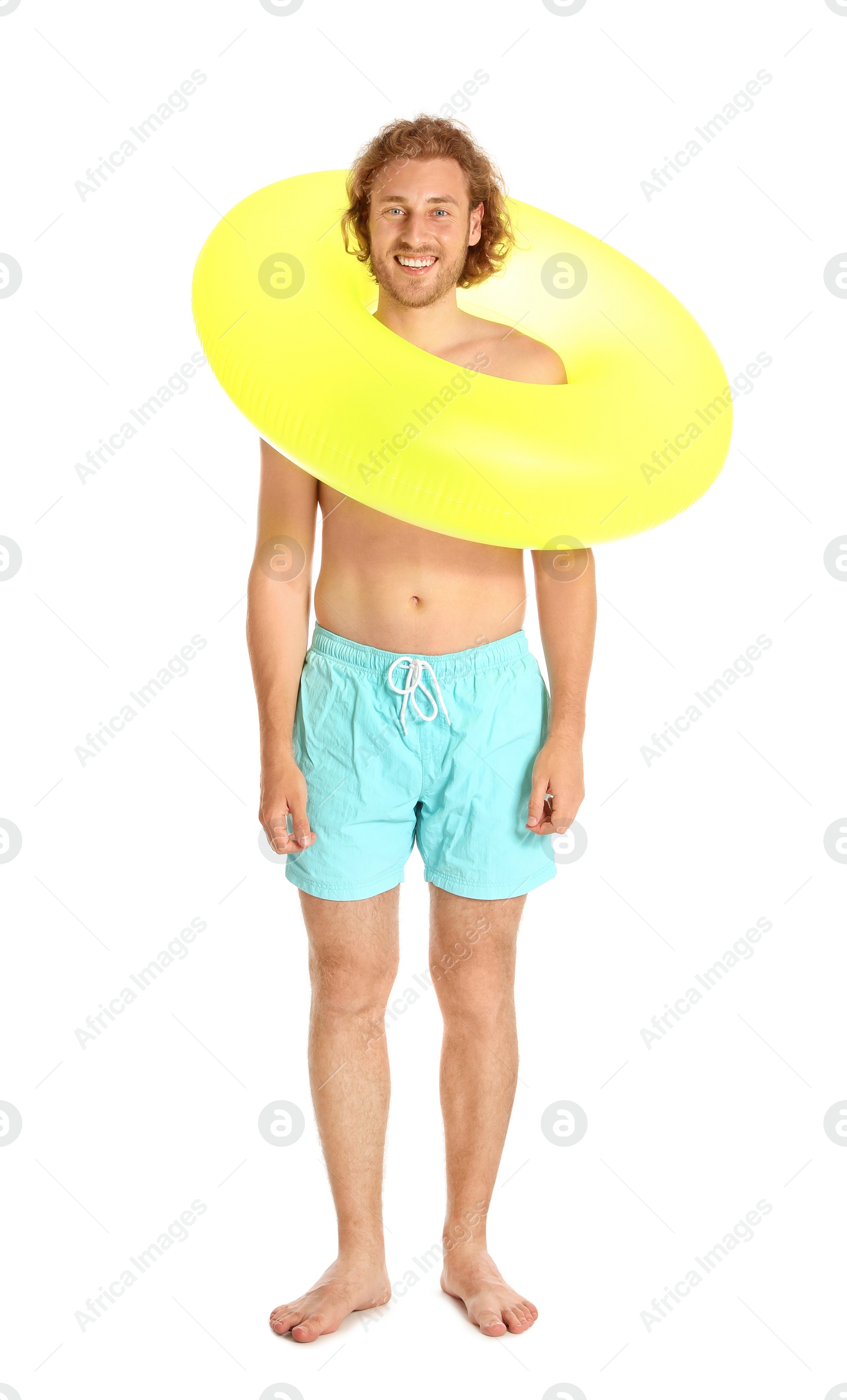 Photo of Attractive young man in swimwear with yellow inflatable ring on white background