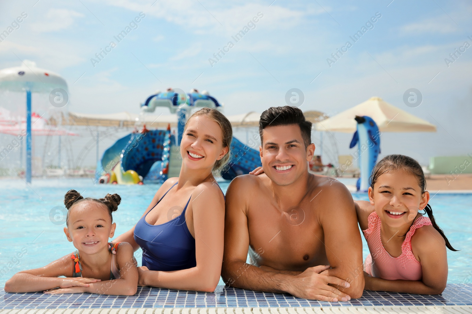 Photo of Happy family in swimming pool at water park