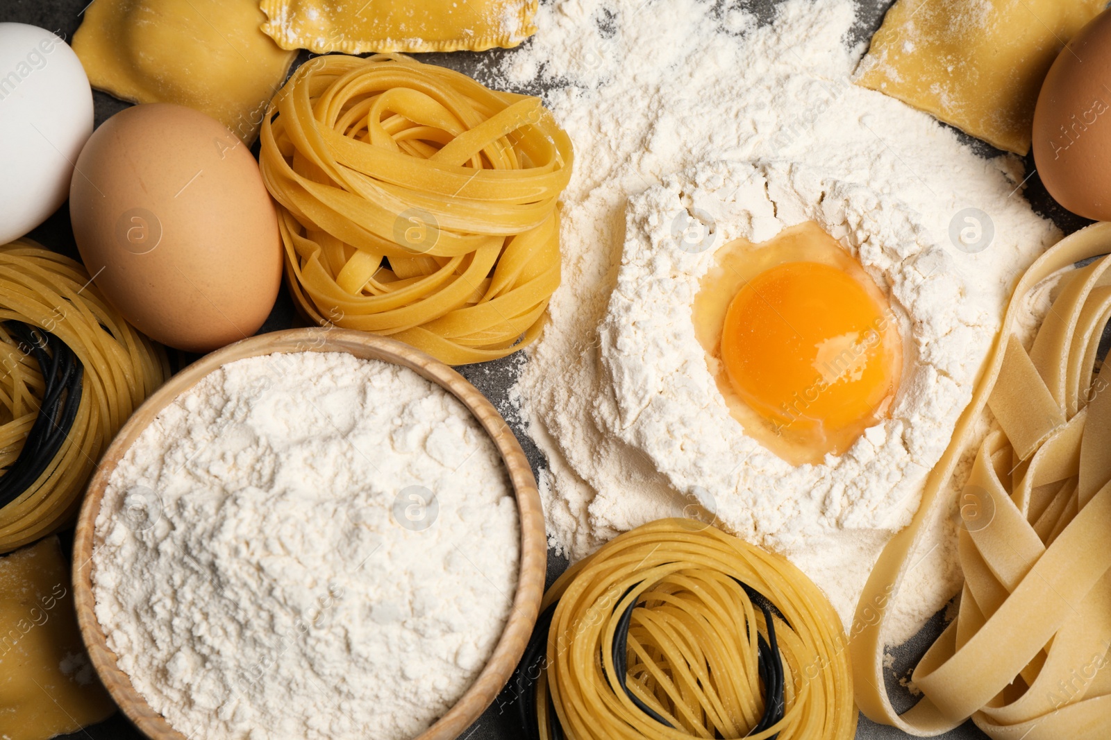 Photo of Different types of pasta and ingredients, top view