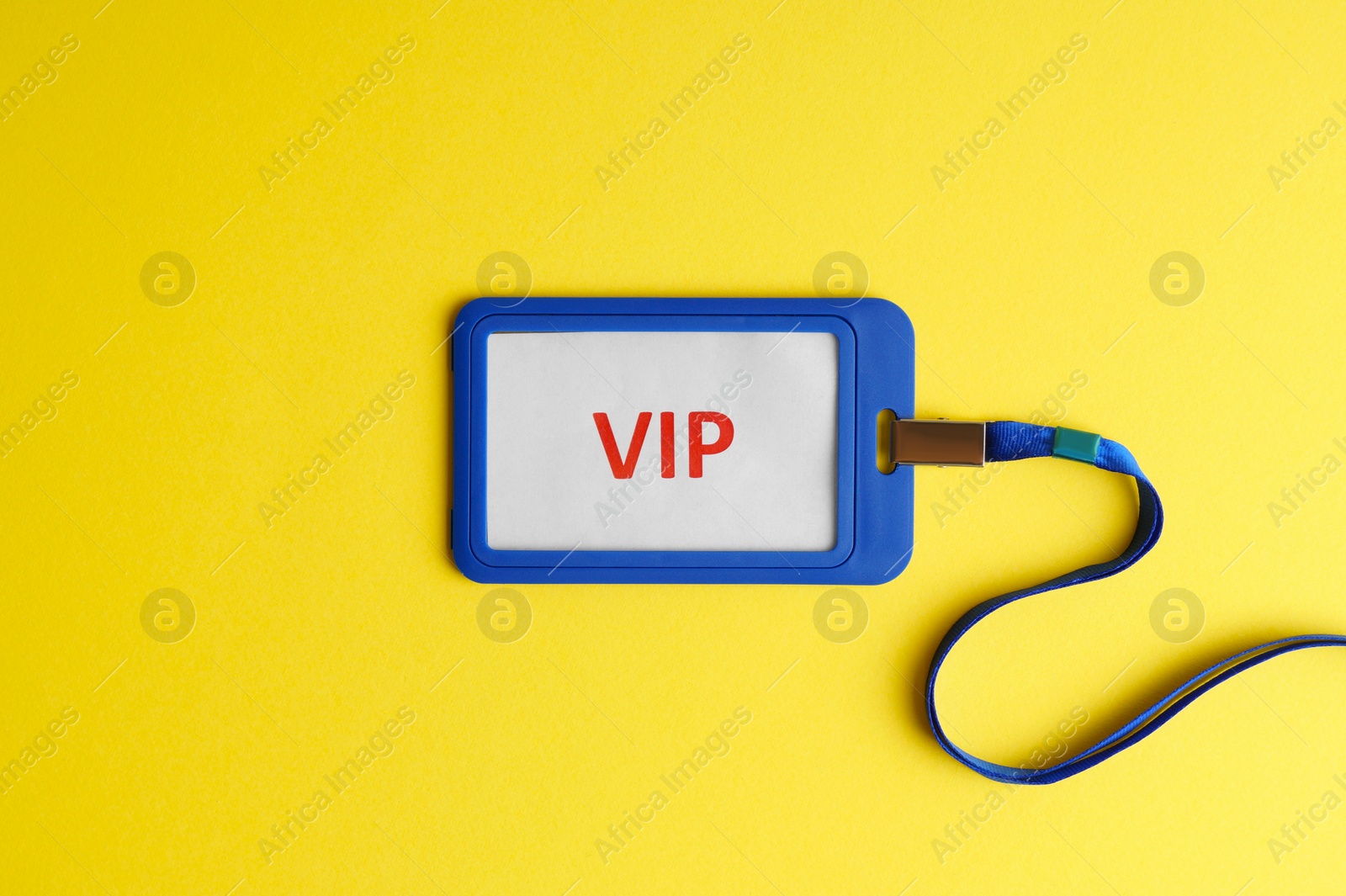 Photo of Vip badge on yellow background, top view. Space for text