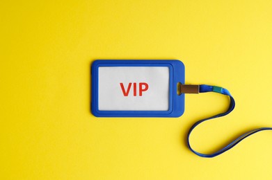 Vip badge on yellow background, top view. Space for text