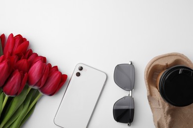 Photo of Flat lay composition with beautiful tulips and smartphone on white table. Space for text
