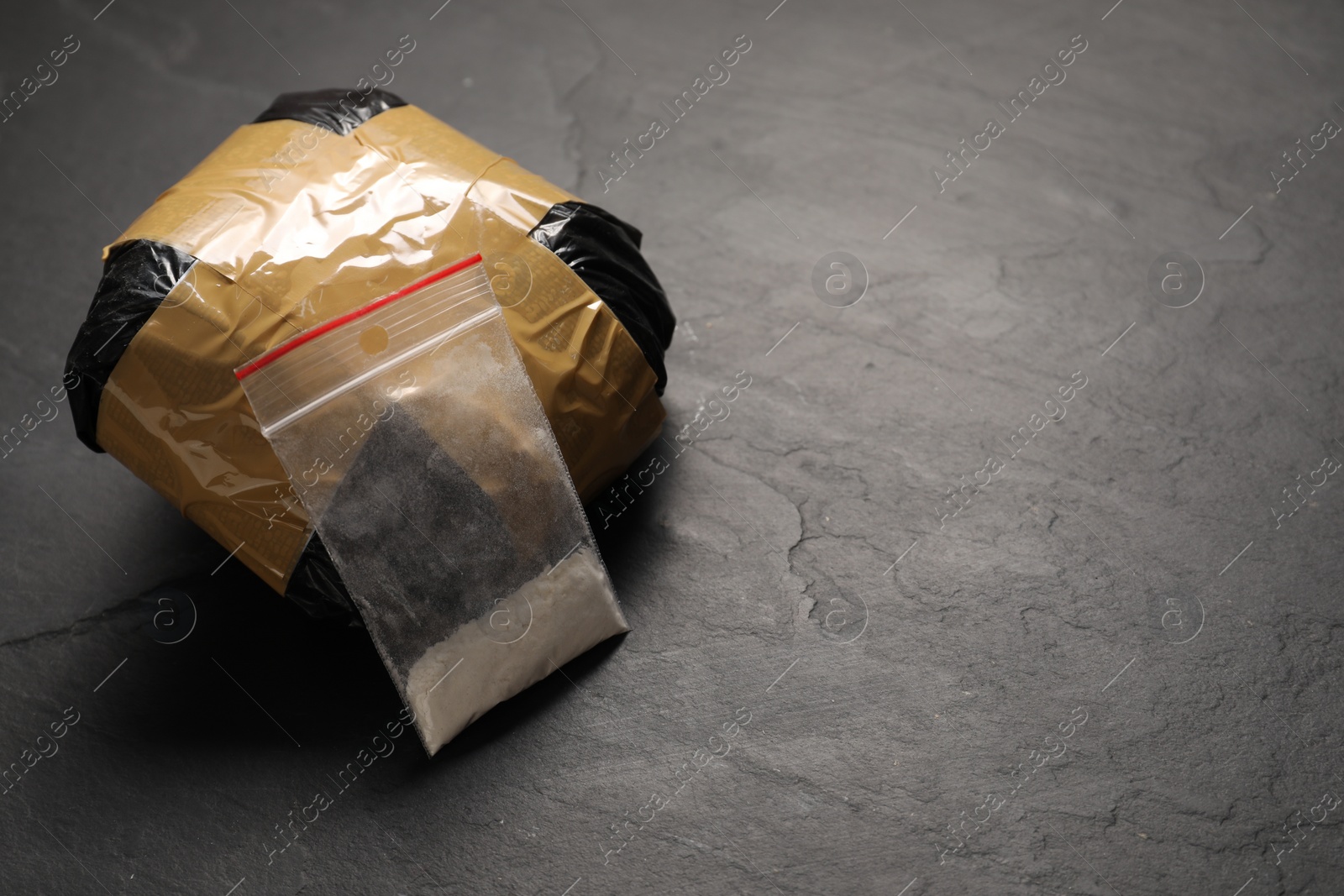 Photo of Packages with narcotics on black table, space for text