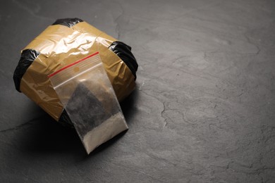 Photo of Packages with narcotics on black table, space for text