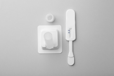 Photo of Disposable express test kit on light grey background, flat lay