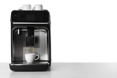 Photo of Making coffee with modern espresso machine on table against white background. Space for text