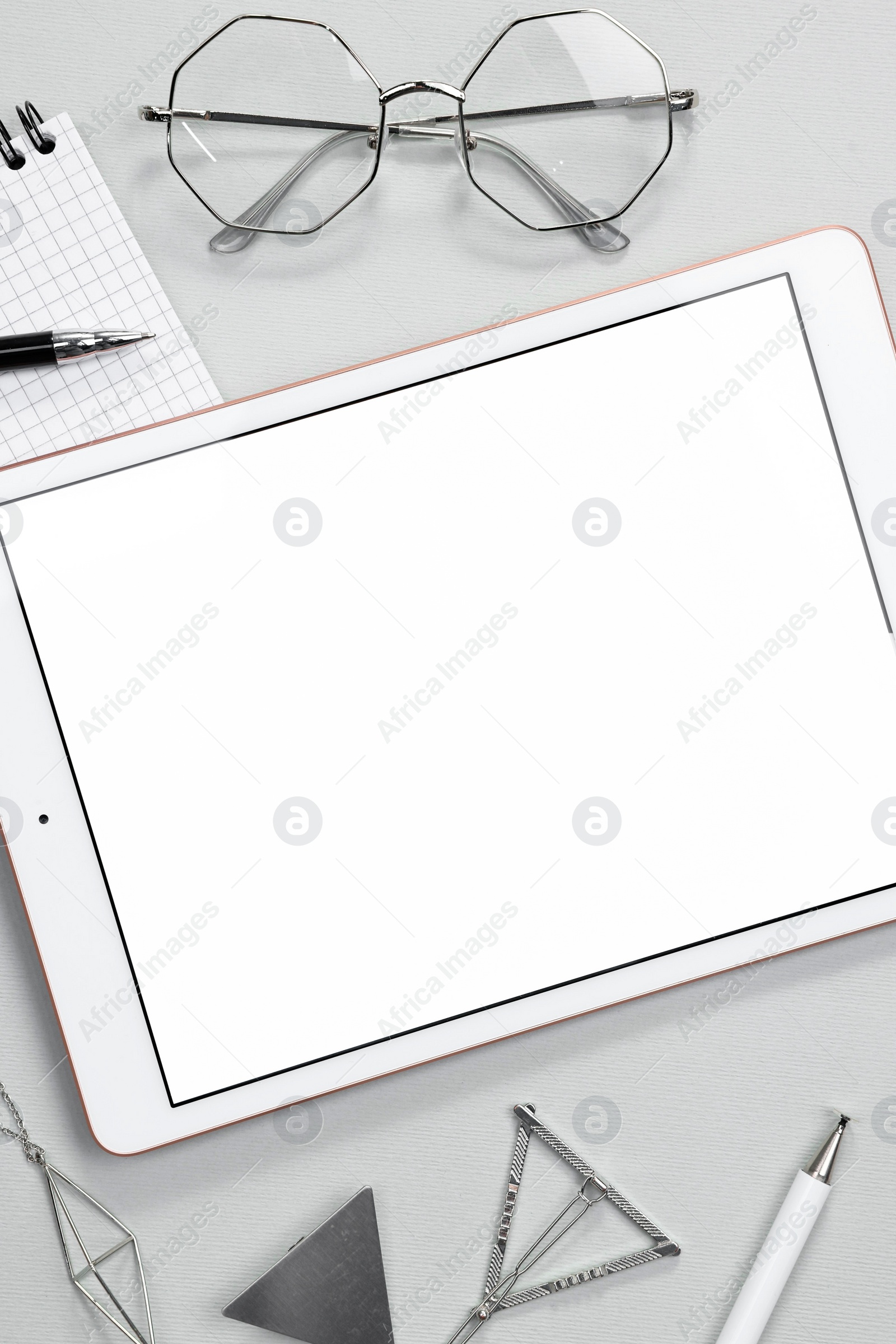 Photo of Flat lay composition with modern tablet on light grey background. Space for text