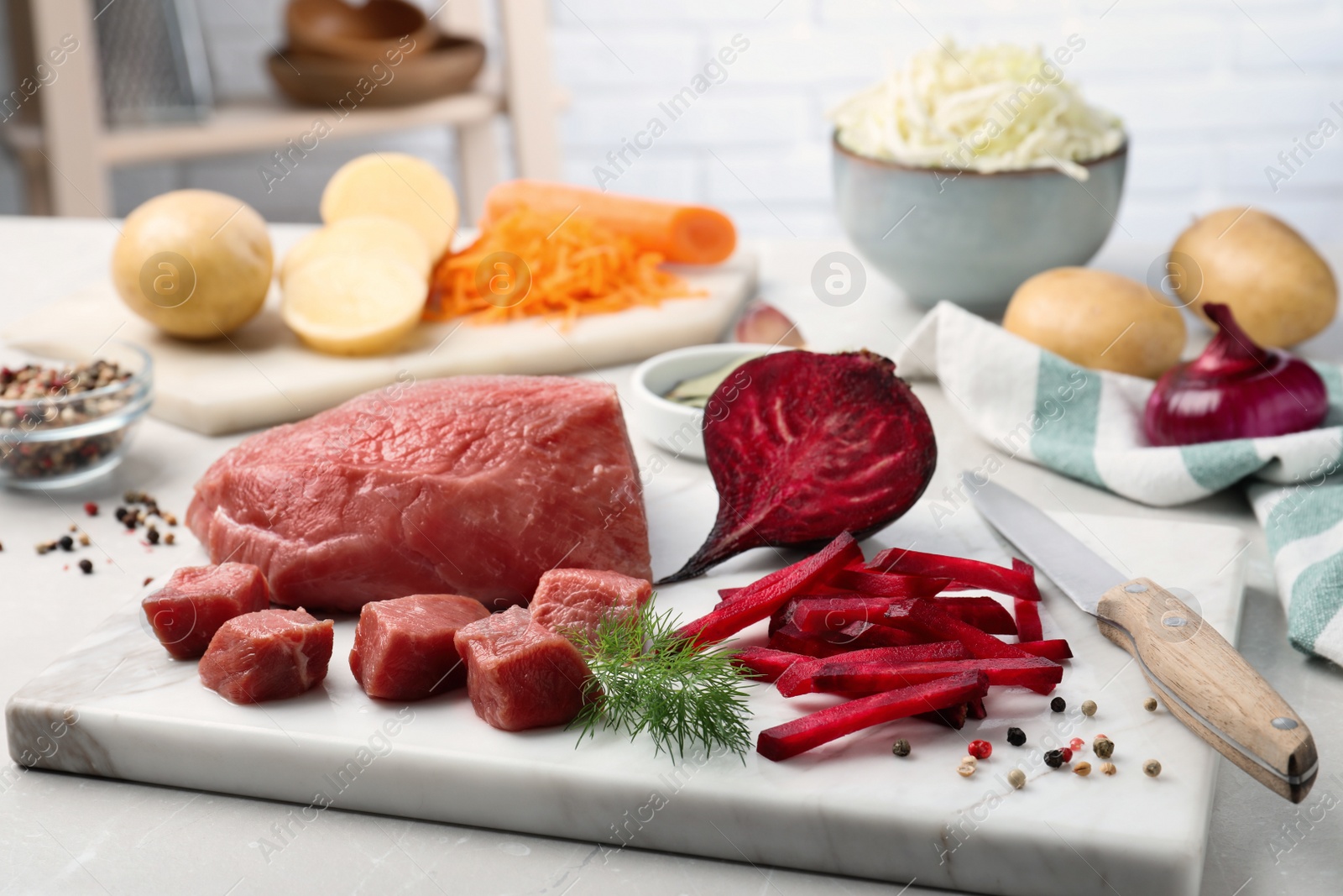 Photo of Fresh ingredients for borscht on light grey table