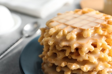 Photo of Plate of waffles and condensed milk on table, closeup with space for text. Dairy product