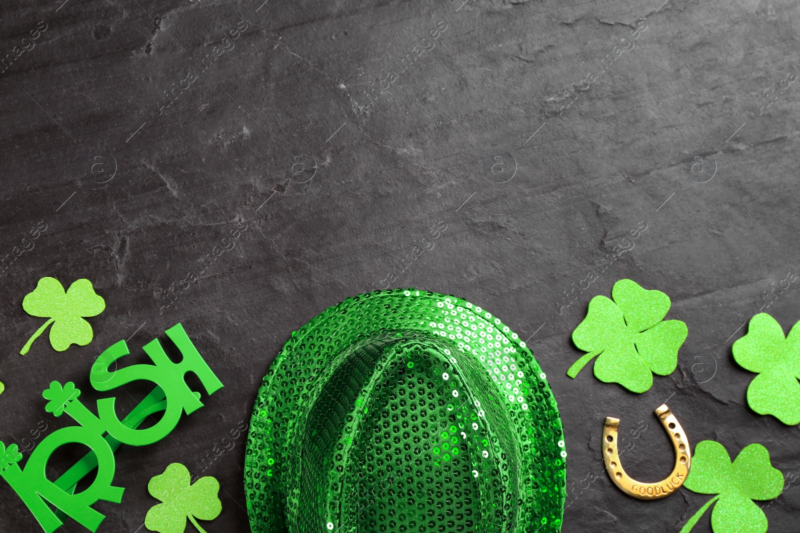 Photo of Leprechaun's hat and St. Patrick's day decor on black background, flat lay. Space for text