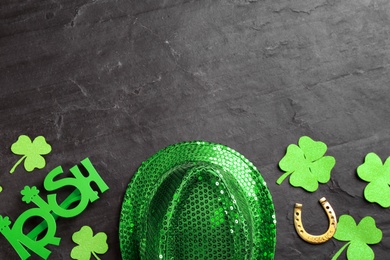 Leprechaun's hat and St. Patrick's day decor on black background, flat lay. Space for text