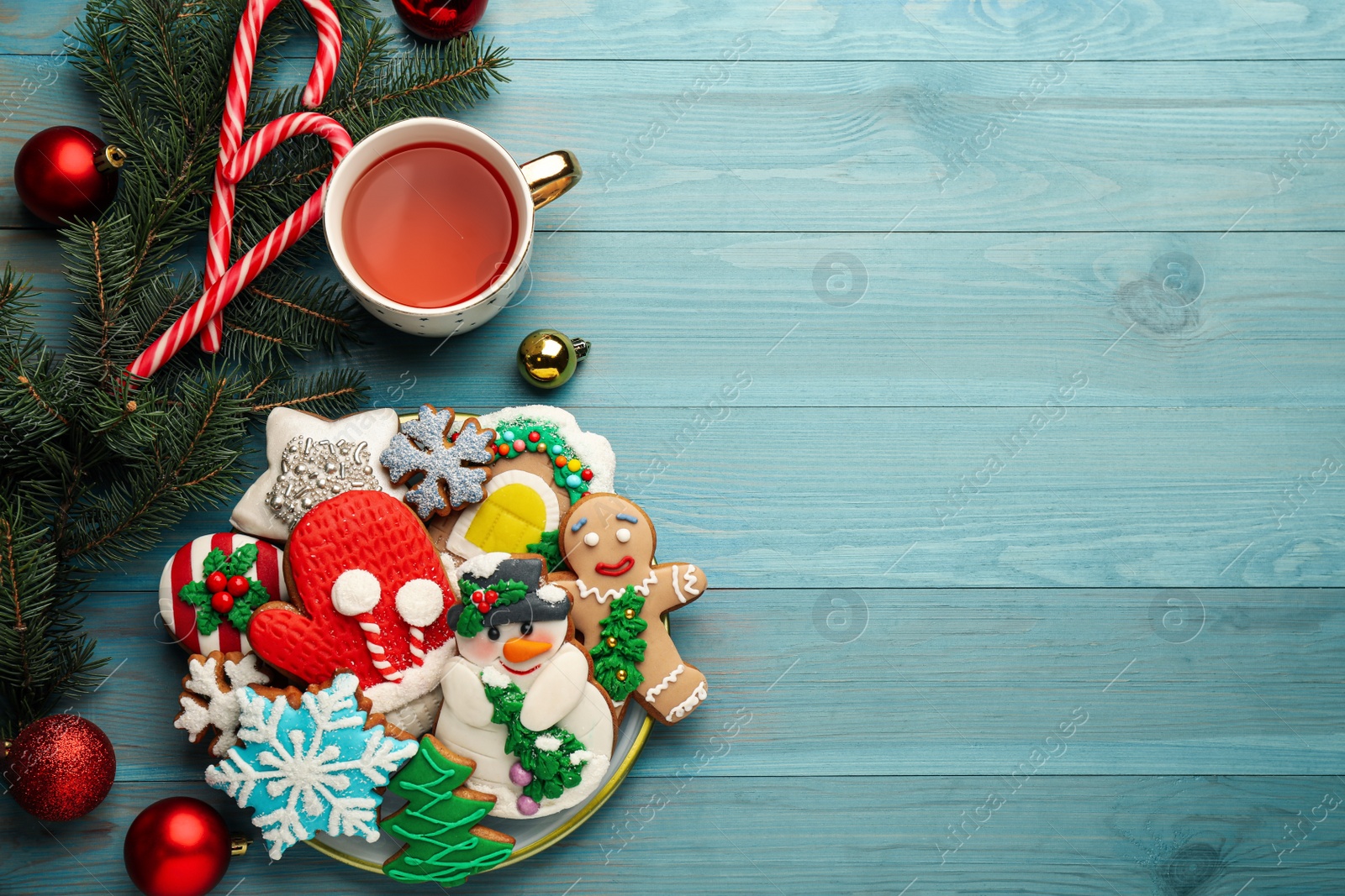 Photo of Flat lay composition with delicious homemade Christmas cookies on turquoise wooden table. Space for text