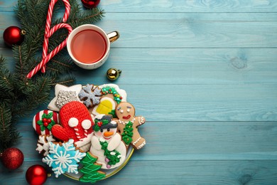 Photo of Flat lay composition with delicious homemade Christmas cookies on turquoise wooden table. Space for text