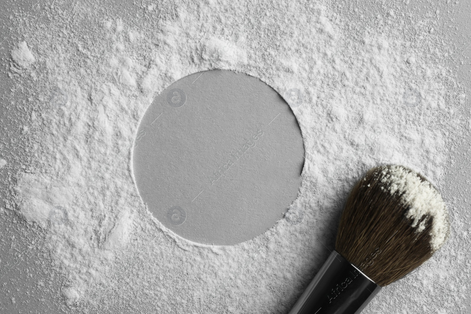 Photo of Frame made of rice loose face powder and makeup brush on light grey background, top view. Space for text