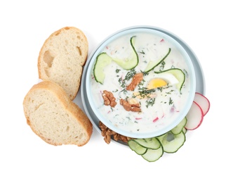 Photo of Delicious cold summer soup and bread on white background, top view