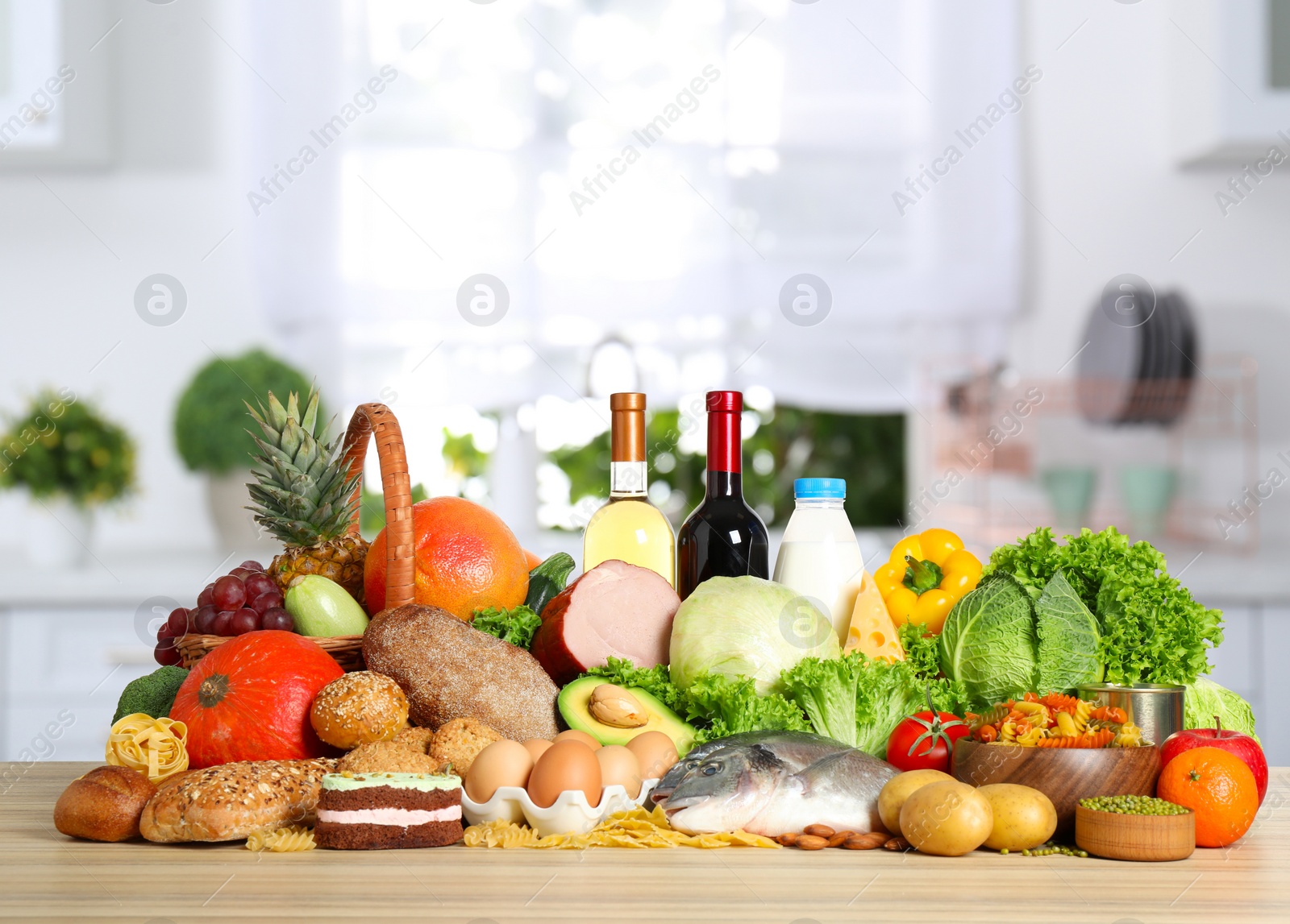 Image of Different products on wooden table in kitchen. Balanced food