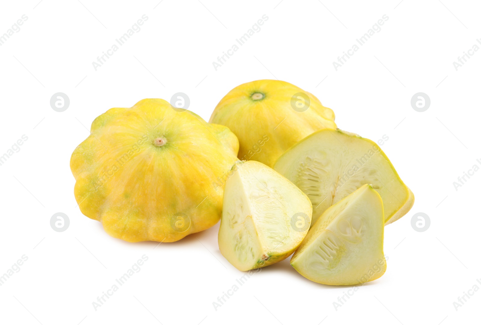 Photo of Whole and cut pattypan squashes on white background