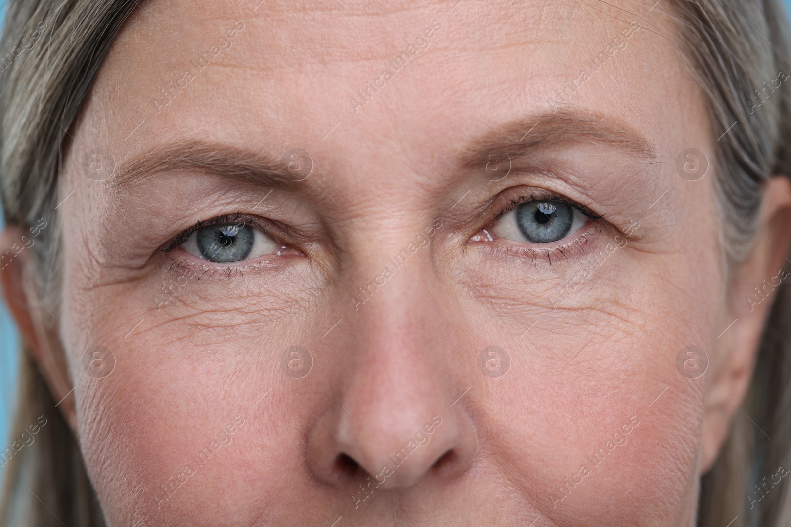 Photo of Closeup view of senior woman's face with aging skin