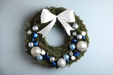 Beautiful Christmas wreath on light background, top view