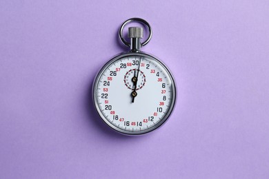 Photo of Vintage timer on violet background, top view