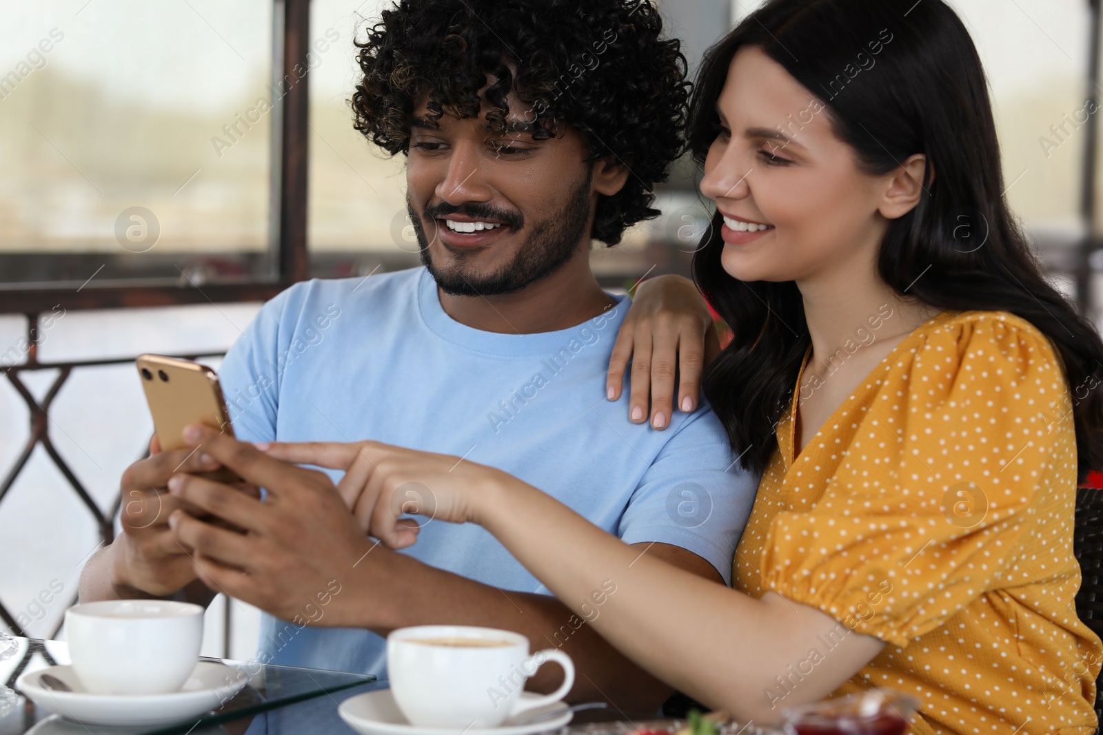 Photo of International dating. Happy couple spending time together in restaurant