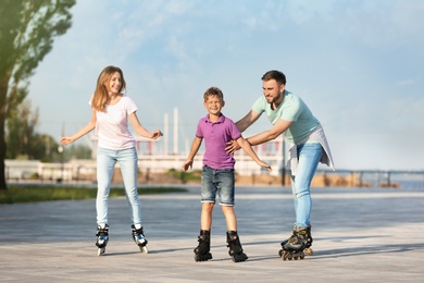 Photo of Happy family roller skating on city street