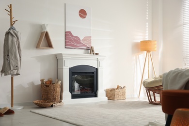 Photo of Bright living room interior with fireplace and baskets of firewood