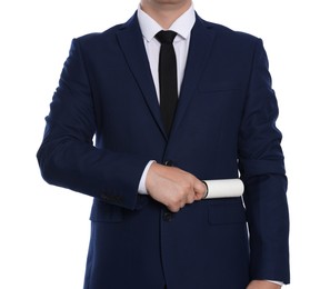 Man cleaning suit with lint roller on white background, closeup