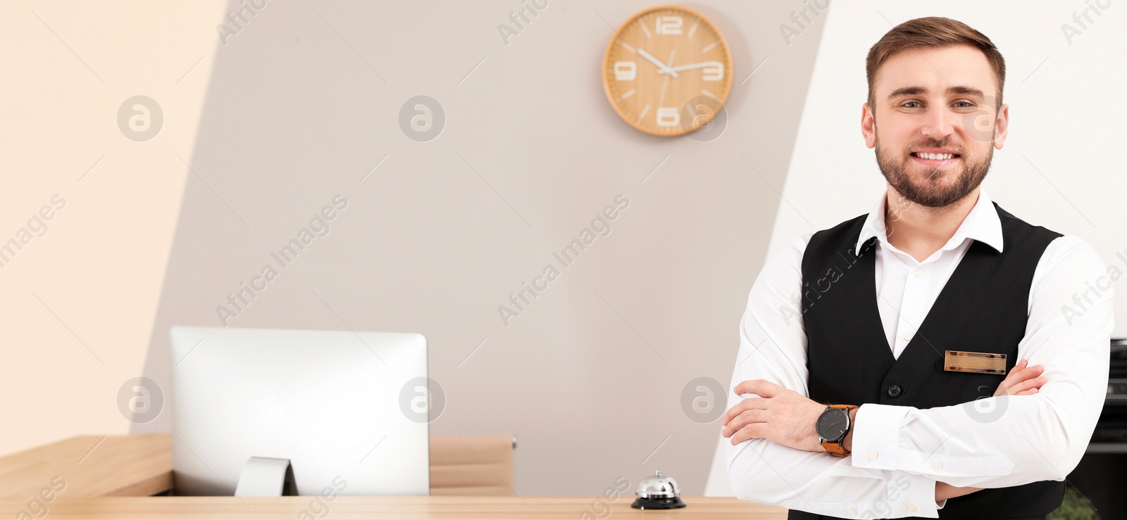 Image of Portrait of receptionist near desk in modern hotel. Banner design