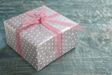 Elegant gift box with bow on wooden background