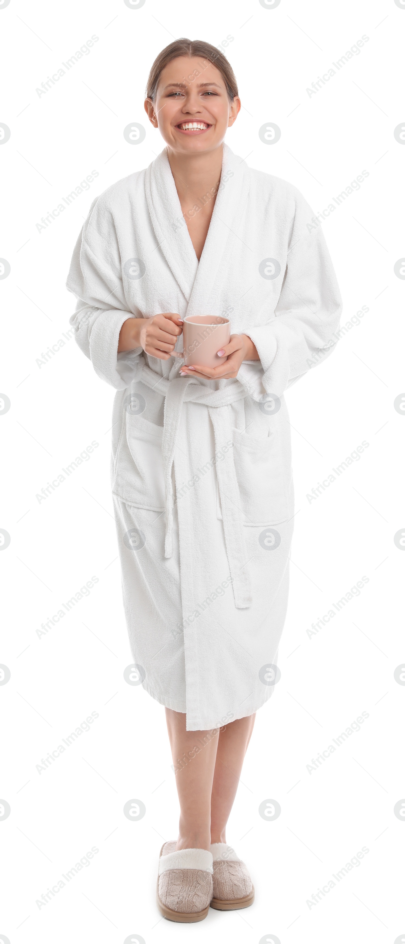 Photo of Young woman in bathrobe with cup of beverage on white background