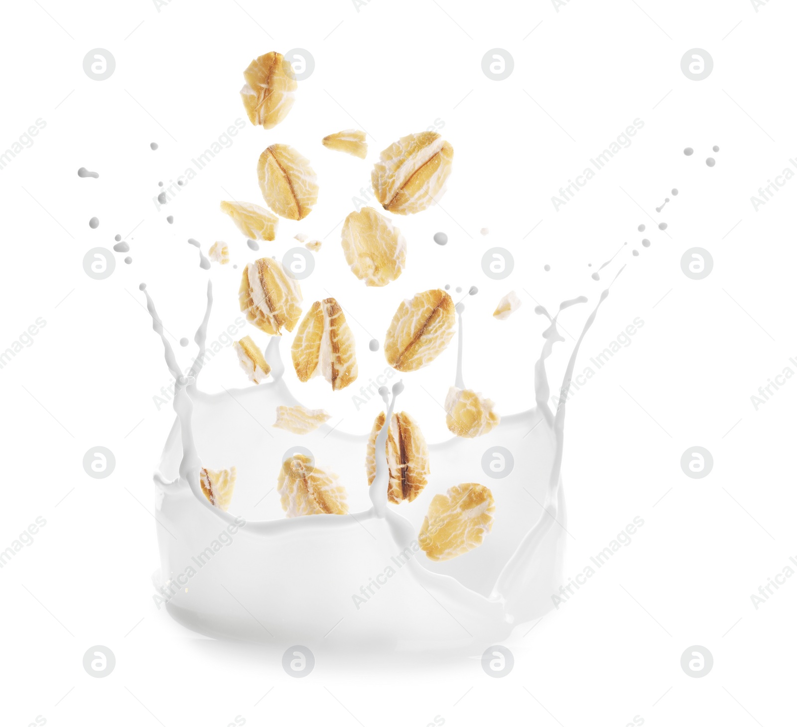 Image of Rolled oats falling into splashing milk on white background