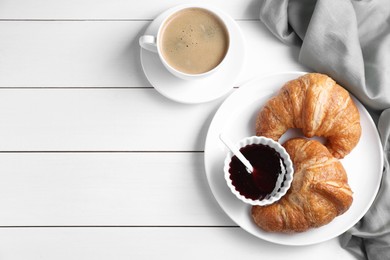 Photo of Breakfast time. Fresh croissants, jam and coffee on white wooden table, flat lay. Space for text