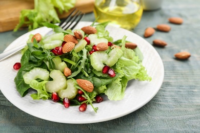 Delicious fresh celery salad on light blue wooden table, closeup