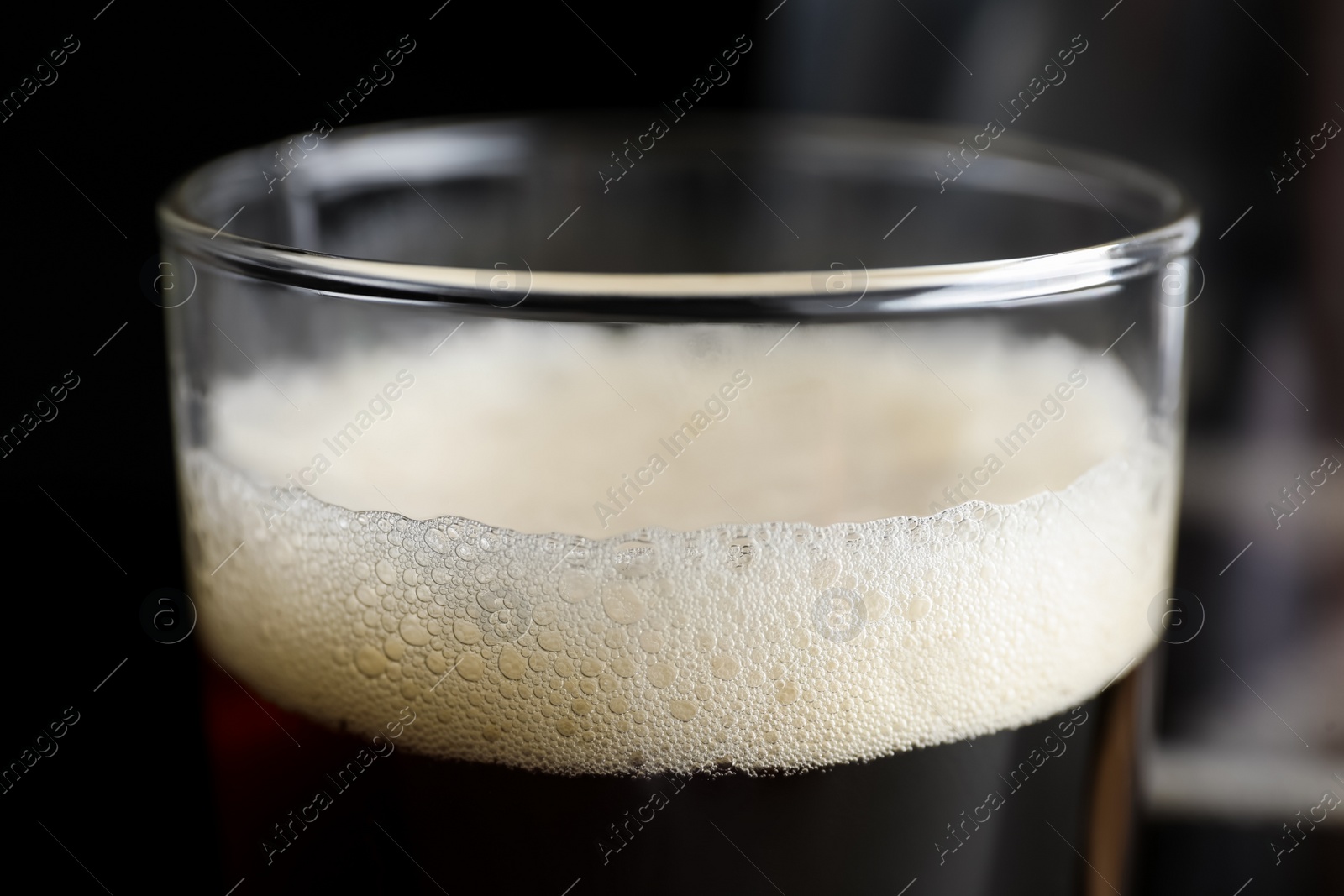 Photo of Glass of delicious kvass on dark background, closeup