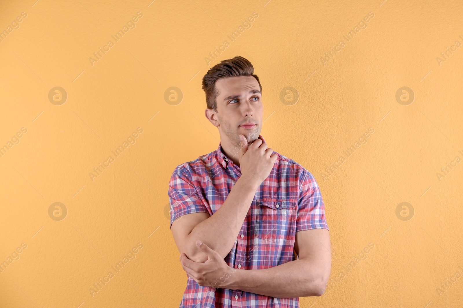 Photo of Handsome young man on color background